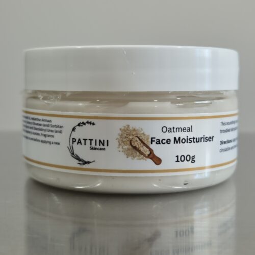 A white jar of Pattini Skincare Oatmeal Face Moisturiser with a beige label featuring an oatmeal graphic, placed on a reflective surface.