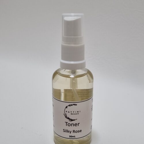A clear spray bottle of Pattini Skincare Silky Rose Face Mist with a white label and pump, placed on a plain white background.