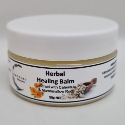 A small white jar of Pattini Skincare Herbal Healing Balm with a label featuring calendula flowers and marshmallow root.