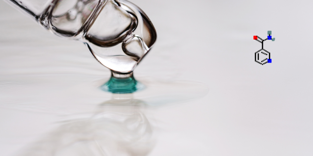 A close-up of a clear dropper releasing a droplet of liquid onto a smooth white surface, with a niacinamide chemical structure diagram shown to the right.