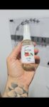 A hand holding a clear spray bottle labeled Silky Rose Face Mist 50mL from Pattini Skincare.