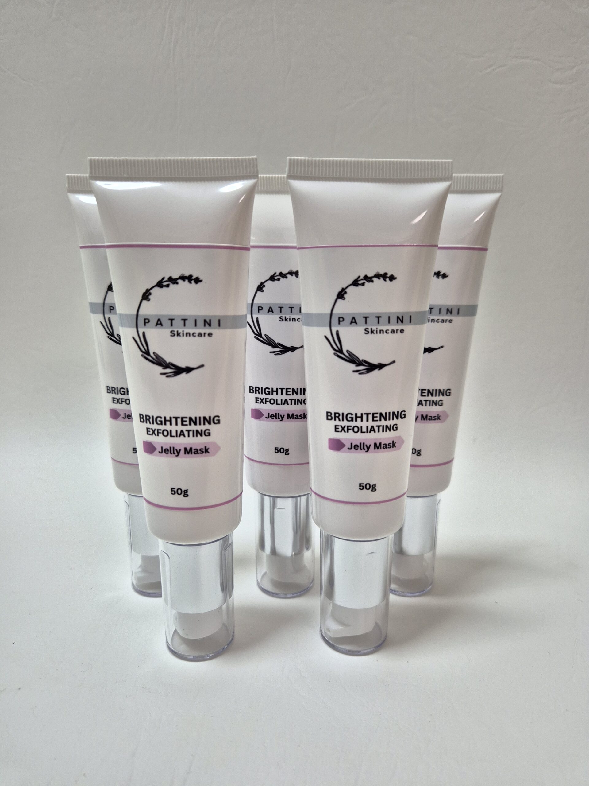 Five tubes of Pattini Skincare Brightening Exfoliating Jelly Mask arranged in a semi-circle on a plain white background