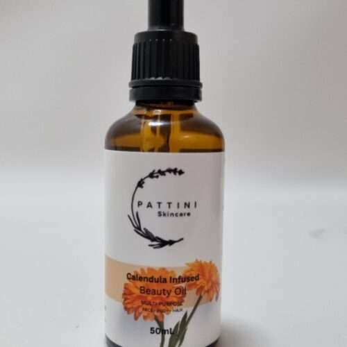 A small amber glass dropper bottle of Pattini Skincare Calendula Herbal Oil placed against a plain white background.